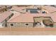 A home backyard featuring a patio, pergola, and stucco wall for privacy, with a view of the tile roof at 2213 Chandler Ranch Pl, Laughlin, NV 89029