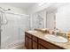 Bathroom with granite countertops, double sinks, and a sleek glass-enclosed shower at 2213 Chandler Ranch Pl, Laughlin, NV 89029