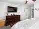 Bedroom featuring a TV, dresser, and comfortable furniture for relaxation at 2213 Chandler Ranch Pl, Laughlin, NV 89029