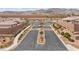 Aerial view of the community entrance with landscaped median, stone walls and desert landscaping at 2213 Chandler Ranch Pl, Laughlin, NV 89029
