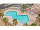 Overhead view of the community pool with lounge chairs, restrooms, desert landscaping, and parking at 2213 Chandler Ranch Pl, Laughlin, NV 89029