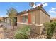 A home with red shutters and a small tree with a patch of greenery at 2213 Chandler Ranch Pl, Laughlin, NV 89029
