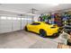 Rear view of a Yellow Camaro and side storage in this 2 car garage at 2213 Chandler Ranch Pl, Laughlin, NV 89029