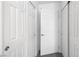 Hallway with multiple white paneled doors, creating a clean and organized look at 2213 Chandler Ranch Pl, Laughlin, NV 89029