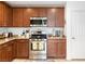 Open kitchen features granite countertops, wooden cabinets, and stainless steel appliances at 2213 Chandler Ranch Pl, Laughlin, NV 89029