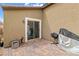 Rear of house featuring sliding glass door and brick patio at 2213 Chandler Ranch Pl, Laughlin, NV 89029