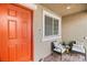 Charming front porch featuring cozy seating and a beautifully painted door, enhancing curb appeal at 2213 Chandler Ranch Pl, Laughlin, NV 89029