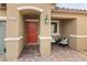 Inviting porch with stylish seating and a vibrant red door, creating a warm welcome at 2213 Chandler Ranch Pl, Laughlin, NV 89029