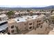 The residence features a well-maintained community with beige buildings, tiled roofs, palm trees, and desert landscaping at 2232 Aspen Mirror Way # 202, Laughlin, NV 89029