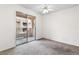 Bedroom featuring neutral carpet, ceiling fan, and sliding glass door at 2232 Aspen Mirror Way # 202, Laughlin, NV 89029