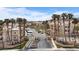Landscaped entrance to a residential community featuring palm trees, well-maintained lawns, and a gated entrance at 2232 Aspen Mirror Way # 202, Laughlin, NV 89029