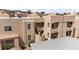 View of the exterior of a multi-unit building with beige stucco, tiled roofs, and well-maintained landscaping at 2232 Aspen Mirror Way # 202, Laughlin, NV 89029