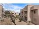 The exterior showcases stucco walls, balconies and desert landscaping, offering a peaceful, low-maintenance lifestyle at 2232 Aspen Mirror Way # 202, Laughlin, NV 89029