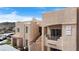 Exterior view of an apartment building with a balcony, patio, and desert landscaping, enhanced by natural light at 2232 Aspen Mirror Way # 202, Laughlin, NV 89029