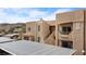 Exterior view of a building featuring a balcony, carport, and desert landscaping in a residential community at 2232 Aspen Mirror Way # 202, Laughlin, NV 89029