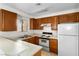 Charming kitchen with wooden cabinets, bright light, and essential appliances, creating a pleasant space for cooking and dining at 2232 Aspen Mirror Way # 202, Laughlin, NV 89029