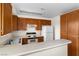 Practical kitchen with wood cabinets and standard appliances, providing a functional cooking space for everyday meal preparation at 2232 Aspen Mirror Way # 202, Laughlin, NV 89029