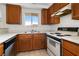 Efficient kitchen with wood cabinets and appliances offering essential amenities, creating a practical cooking environment at 2232 Aspen Mirror Way # 202, Laughlin, NV 89029
