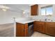Efficient kitchen with basic appliances and wooden cabinets, opening to a living area for easy entertaining and everyday living at 2232 Aspen Mirror Way # 202, Laughlin, NV 89029