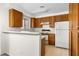 Traditional kitchen features wooden cabinets, white appliances, and a breakfast bar, with ample counter space and natural lighting at 2232 Aspen Mirror Way # 202, Laughlin, NV 89029