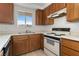 Functional kitchen featuring wood cabinets, a window offering natural light, and basic appliances for comfortable meal preparation at 2232 Aspen Mirror Way # 202, Laughlin, NV 89029