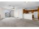 Bright living room open to the kitchen featuring neutral carpet, ceiling fan and sliding glass door at 2232 Aspen Mirror Way # 202, Laughlin, NV 89029