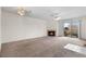 Spacious living room with carpet, fireplace, sliding glass door and ceiling fan at 2232 Aspen Mirror Way # 202, Laughlin, NV 89029