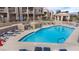 Beautiful community pool with lounge chairs for relaxing, surrounded by well-maintained grounds in a residential setting at 2232 Aspen Mirror Way # 202, Laughlin, NV 89029