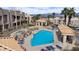 Community pool with lounge chairs, cabana, and mature trees offering shade in a picturesque residential community at 2232 Aspen Mirror Way # 202, Laughlin, NV 89029