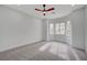 Bright bedroom boasts natural light from multiple windows and neutral carpeting at 2353 Lauren Dr, Las Vegas, NV 89134