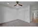 Bright bedroom with grey carpet, ceiling fan, and closet at 2353 Lauren Dr, Las Vegas, NV 89134