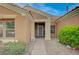 Inviting front entrance with a stone pathway, complemented by a tiled roof and lush landscaping at 2353 Lauren Dr, Las Vegas, NV 89134