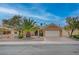 Well-maintained home featuring lush landscaping, mature trees, and a two-car garage at 2353 Lauren Dr, Las Vegas, NV 89134