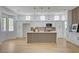 Bright kitchen featuring wood floors, modern appliances, and kitchen island at 2353 Lauren Dr, Las Vegas, NV 89134