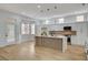 Modern kitchen with white cabinets, marble island, stainless steel appliances and hardwood floors at 2353 Lauren Dr, Las Vegas, NV 89134