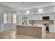 Modern kitchen with white cabinets, large island, stainless steel appliances and hardwood floors at 2353 Lauren Dr, Las Vegas, NV 89134