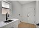 Functional laundry room with a modern sink, white cabinets, and convenient layout at 2353 Lauren Dr, Las Vegas, NV 89134