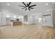 Bright, open-concept living room featuring wood floors, large windows, and a modern fireplace at 2353 Lauren Dr, Las Vegas, NV 89134