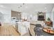Bright, open-concept living space featuring a modern kitchen with a marble island and a comfortable seating area at 2353 Lauren Dr, Las Vegas, NV 89134