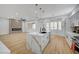 Open concept living space with a stunning kitchen island and modern fireplace feature at 2353 Lauren Dr, Las Vegas, NV 89134