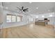 Bright, open-concept living room featuring wood floors, large windows, and a modern fireplace at 2353 Lauren Dr, Las Vegas, NV 89134