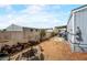 View of the backyard with wood and a small tree near a light gray home at 240 Navajo Dr, Henderson, NV 89015