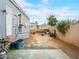 Outside the home is a backyard with a wood burning fireplace pit, near a light gray home at 240 Navajo Dr, Henderson, NV 89015