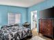Bedroom with a bed, dresser, window, and doorway to a bathroom at 240 Navajo Dr, Henderson, NV 89015