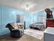 Bedroom with a bed, recliner, dresser, tv, and two windows at 240 Navajo Dr, Henderson, NV 89015