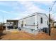 Exterior of the home featuring gray siding, white trim, and a covered carport at 240 Navajo Dr, Henderson, NV 89015