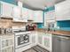 Bright kitchen features white appliances and cabinets, a window over the sink, and modern lighting at 240 Navajo Dr, Henderson, NV 89015