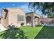 Well-kept backyard showcasing an artificial grass lawn, cozy patio, and privacy at 2673 Paris Amour St, Henderson, NV 89044