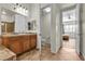 Bright bathroom featuring double sinks, toilet and access to a bedroom at 2673 Paris Amour St, Henderson, NV 89044