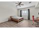 Bedroom includes a ceiling fan, window with plantation shutters, and wood-look flooring at 2673 Paris Amour St, Henderson, NV 89044